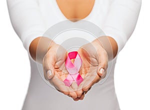 Hands holding pink breast cancer awareness ribbon