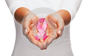 Hands holding pink breast cancer awareness ribbon