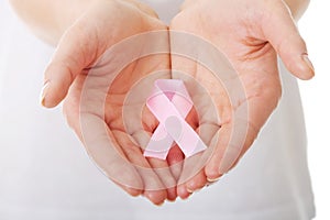 Hands holding pink breast cancer awareness ribbon