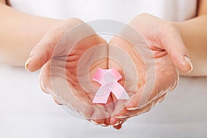 Hands holding pink breast cancer awareness ribbon