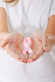 Hands holding pink breast cancer awareness ribbon