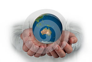 hands holding planet focusing oceania