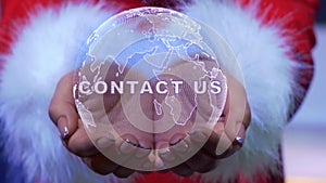 Hands holding planet with text Contact us