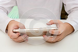 Hands holding playing game on smartphone
