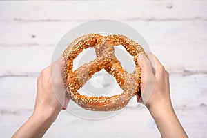 Hands Holding A Pretzel 