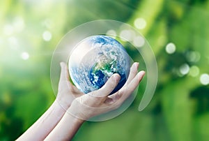 Hands holding and protect earth on nature background