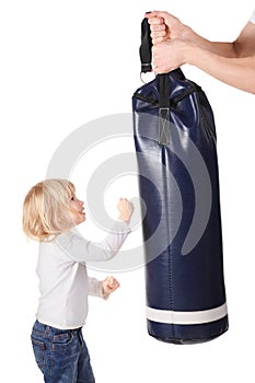 Hands is holding punching bag and girl is punching