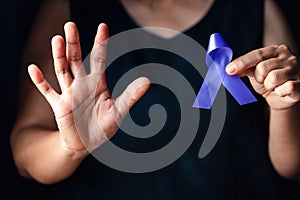 Hands holding purple ribbon symbol of Alzheimer disease, world Lupus. Day and world cancer day. Pancreatic cancer, fibromyalgia