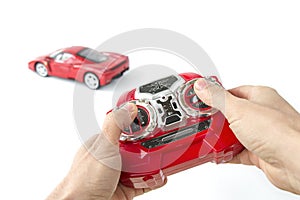 hands holding a radio remote control controller of a toy car