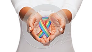 Hands holding rainbow gay pride awareness ribbon