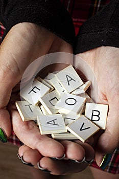Hands holding random alphabet letters