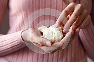 Hands holding raw shea butter or karite