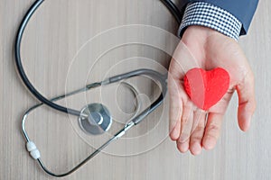 Hands holding Red heart and stethoscope