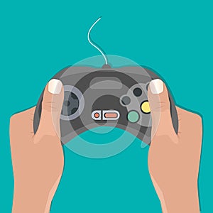 Hands holding retro wired gamepad photo
