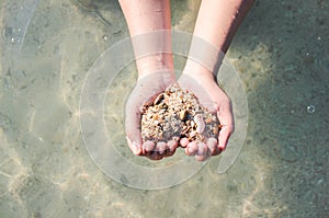 Hands holding a sand in form of the heart