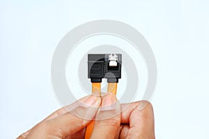 Hands holding Serial ATA wire for computer harddisk on white background