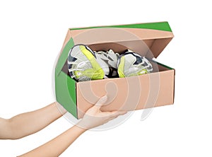 Hands holding shoes in a box