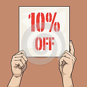 Hands holding a sign card that says 10% off sale