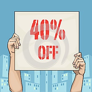 Hands holding a sign that says 40% off, with urban background