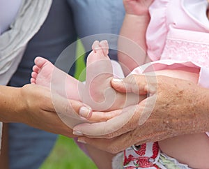 Hands holding small baby feet