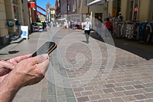 Hands are holding a smart phone with a contact tracing app against coronavirus and Covid 19 pandemic, an German corona warn