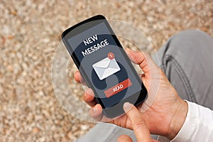 Hands holding smart phone with new message concept on screen