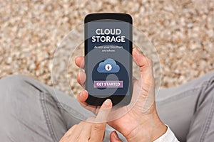 Hands holding smartphone with cloud storage app concept on scree