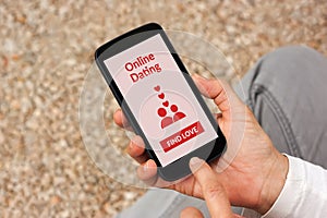 Hands holding smartphone with online dating application mock up