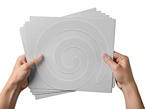 Hands holding a stack of blank gray paper sheets