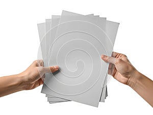 Hands holding a stack of gray paper sheets