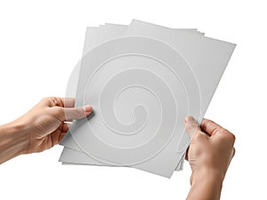 Hands holding a stack of light gray sheets of paper