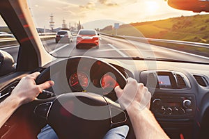 Hands holding on steering wheel while driving