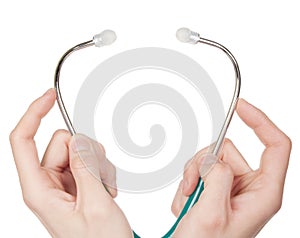 Hands holding a stethoscope isolated on white