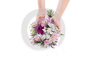 Hands holding a summer bouquet from pink and purple gillyflowers and alstroemeria on white