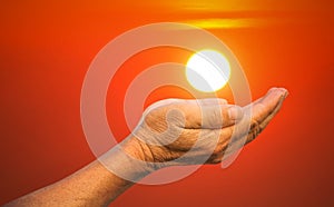 Hands holding the sun.