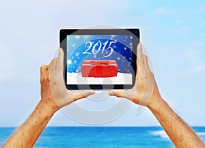 Hands holding a tablet with Christmas greeting