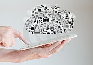Hands holding tablet with cloud computing and mobility concept photo