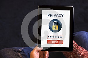 Hands holding tablet computer with online privacy concept on screen