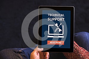 Hands holding tablet computer with technical support concept on