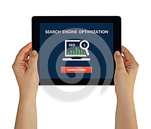 Hands holding tablet with SEO concept on screen