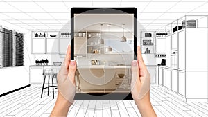 Hands holding tablet showing modern white and wooden kitchen. Blueprint CAD sketch background, augmented reality concept,
