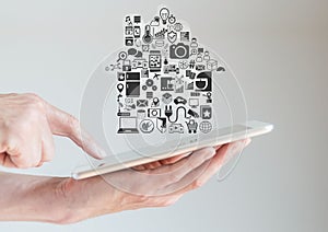 Hands holding tablet with smart home automation and mobility concept
