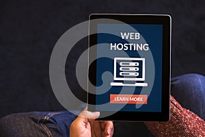 Hands holding tablet with web hosting concept on screen