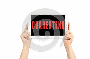 Hands holding a tablet on a white background with quarantine text in spanish photo