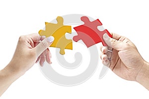 Hands holding two matching jigsaw pieces