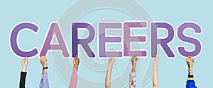 Hands holding up purple letters forming the word careers