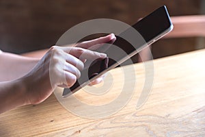 Hands holding , using and touching a tablet pc in modern cafe