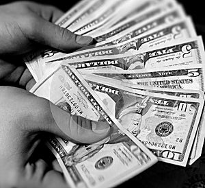 Hands Holding Various Amounts of American Money photo