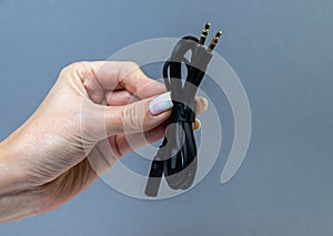 Hands holding various converter cables adapters for computers and smartphones