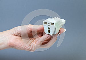 Hands holding various converter cables adapters for computers and smartphones